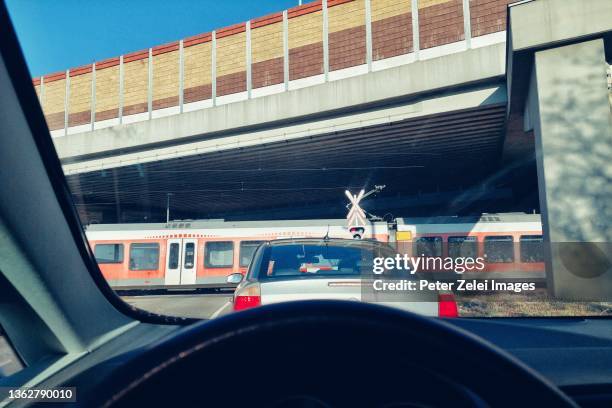 railroad crossing with train, view from a car - train hungary stock pictures, royalty-free photos & images