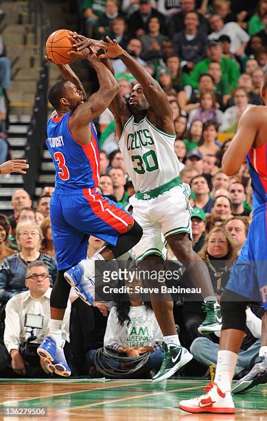 Brandon Bass of the Boston Celtics tries to block the shot against Rodney Stuckey of the Detroit Pistons on December 30, 2011 at the TD Garden in...