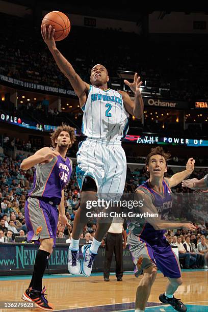 Jarrett Jack of the New Orleans Hornets makes a layup over Steve Nash of the Phoenix Suns at New Orleans Arena on December 30, 2011 in New Orleans,...