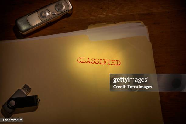 folder marked classified with spy camera and thumb drive - unknown stock pictures, royalty-free photos & images