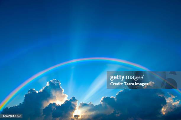 double rainbow and clouds on sky at sunset - rainbow sky stock pictures, royalty-free photos & images