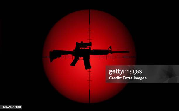 target crosshair with ar-15 rifle against red and black background - ar 15 bildbanksfoton och bilder