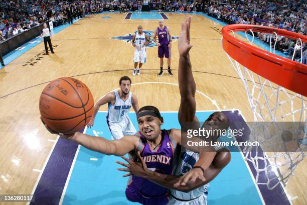 Jared Dudley of the Phoenix Suns goes up for a layup while being guarded by Emeka Okafor of the New Orleans Hornets during an NBA game on December...