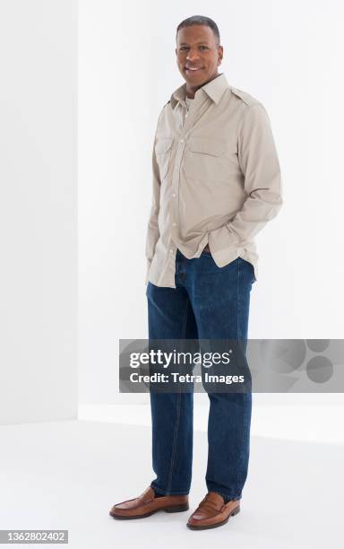 portrait of mature man, studio shot - black trousers stockfoto's en -beelden