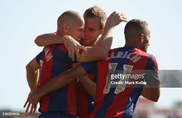Kasey Wehrman, Jeremy Brockie and Tarek Elrich of the Jets celebrate after Wehrman scored a goal during the round 13 A-League match between the...