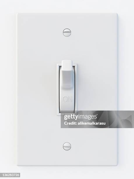 white light switch in the on position - switching stock pictures, royalty-free photos & images