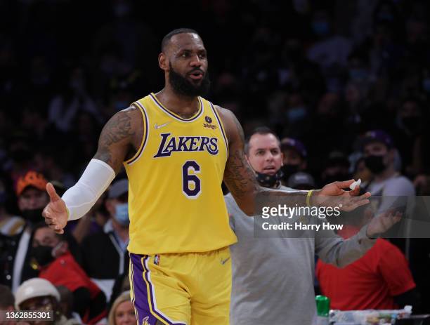 LeBron James of the Los Angeles Lakers reacts for a call from the officials in front of head coach Frank Vogel during a 122-114 Lakers win over the...