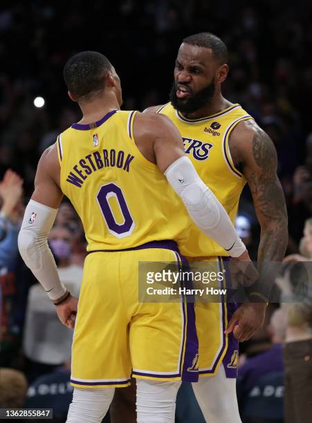 LeBron James of the Los Angeles Lakers celebrates his basket and a Sacramento Kings foul with Russell Westbrook during a 122-114 Los Angeles Lakers...