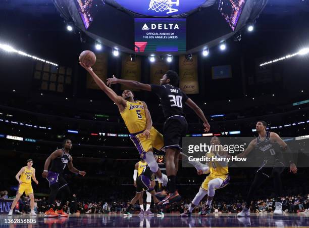 Talen Horton-Tucker of the Los Angeles Lakers scores as he is fouled by Damian Jones of the Sacramento Kings during a 122-114 Los Angeles Lakers win...