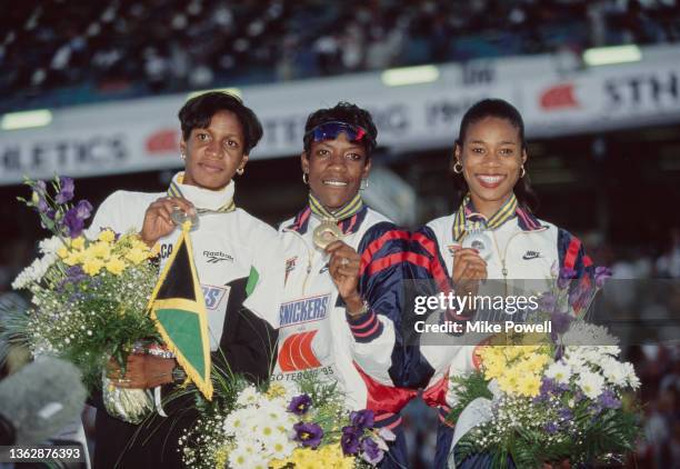 Gold medallist Kim Batten of the United States stands on the victory podium with silver medallist compatriot Tonja Buford and bronze medallist Deon...