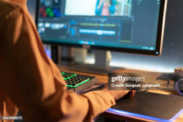 beautiful female video editor works with footage on her personal computer, she works in creative office studio. - video editing foto e immagini stock