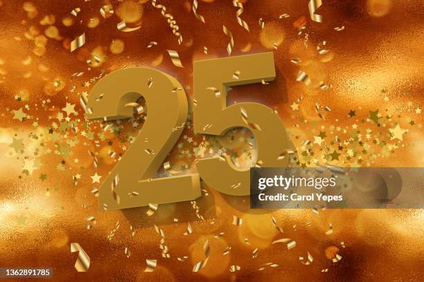 number 25 in golden letters with confetti - 25th anniversary party stock-fotos und bilder