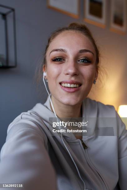joyful teenage girl looking at camera as if she is on a video call - selfie girl stockfoto's en -beelden