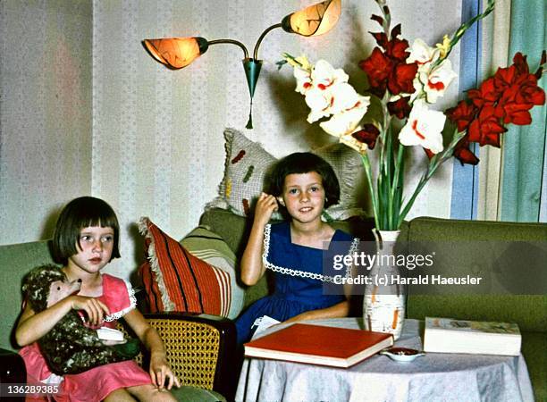 two little red and blue dressed girls - red dress child stockfoto's en -beelden