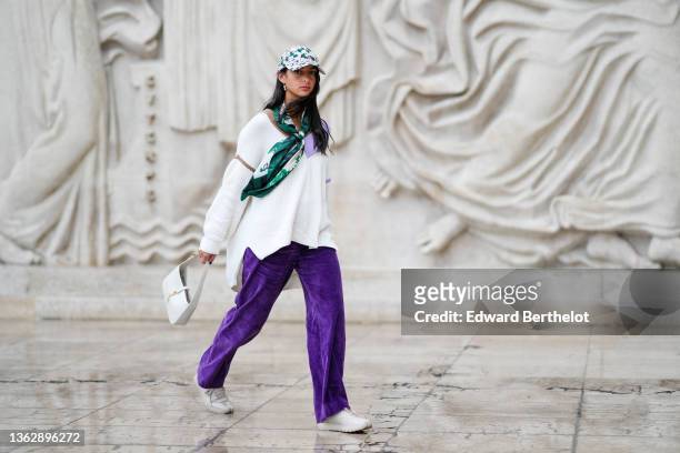 Melanie Darmon wears a white purple and green car hat with floral print from Claudie Pierlot, a silk long scarf with green floral print from Claudie...