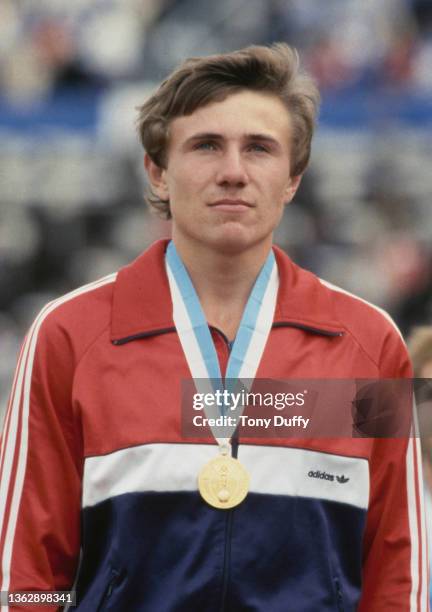 Sergey Bubka of the Soviet Union stands on the podium after receiving the gold medal for winning the Men's Pole Vault competition at the inaugural...