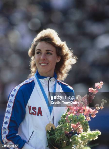 Mary Decker of the United States stands on the podium after receiving her gold medal for winning the Women's 1500 metres event at the inaugural...