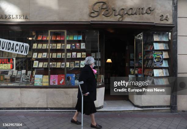 Woman in front of the window of the Pergamo bookstore, the day it closes its doors, on January 5 in Madrid, Spain. The bookstore was opened in 1945...