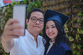 Proud Husband Taking a Selfie with His Wife on Her Postgraduate Graduation Day