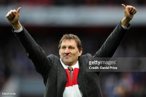 Arsenal legend Tony Adams waves to the fans before the Barclays Premier League match between Arsenal and Queens Park Rangers at Emirates Stadium on...