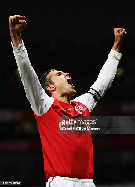 Robin van Persie of Arsenal celebrates scoring his 35th Premier League goal of the year during the Barclays Premier League match between Arsenal and...