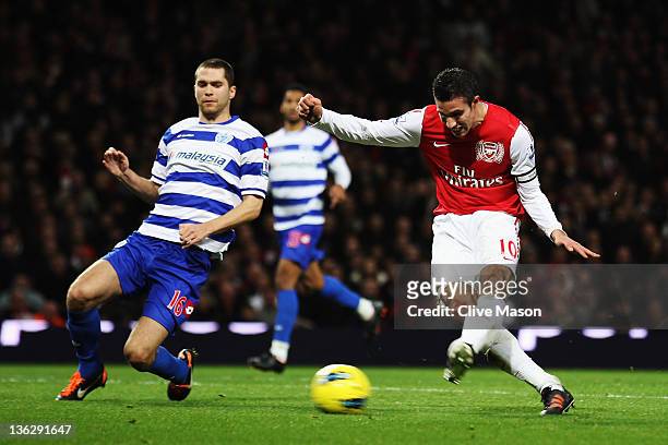 Robin van Persie of Arsenal scores his 35th Premier League goal of the year during the Barclays Premier League match between Arsenal and Queens Park...