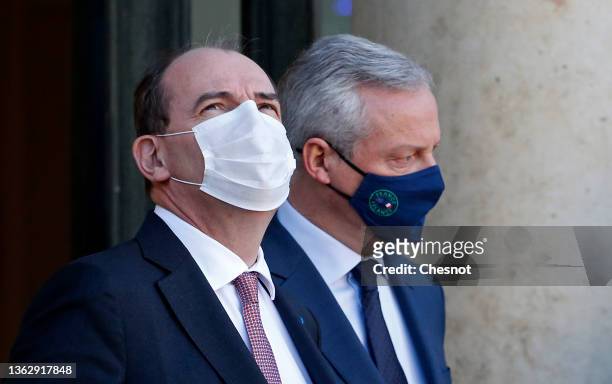 French minister of Economy Bruno Le Maire and French Prime Minister Jean Castex wearing protective face masks leave the Elysee Palace after the first...
