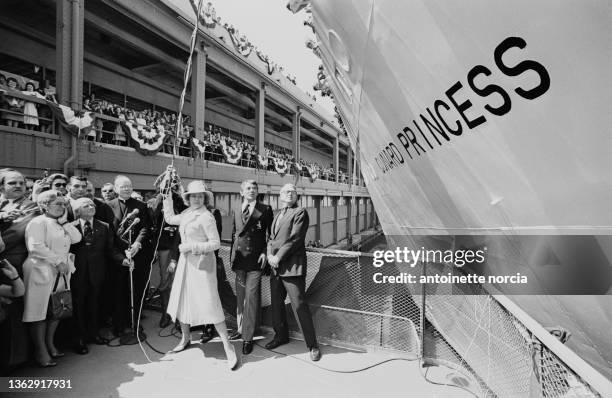 Princess Grace of Monaco hurls champagne bottle towards the new cruise liner Cunard Princess, christening the vessel in New York Harbor. The Cunard...