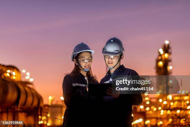 petroleum oil refinery engineer worker in oil and gas industrial with personal safety equipment ppe to inspection follow checklist by tablet. - oil and gas workers imagens e fotografias de stock