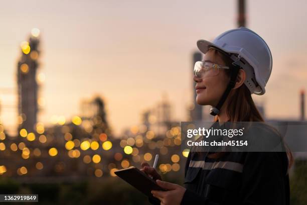 petroleum oil refinery engineer worker in oil and gas industrial with personal safety equipment ppe to inspection follow checklist by tablet. - refinaria - fotografias e filmes do acervo
