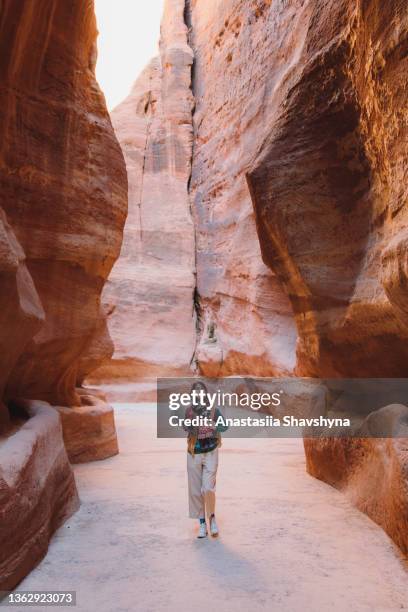 viajera explorando el antiguo mundo de petra en jordania caminando dentro del cañón - the siq fotografías e imágenes de stock