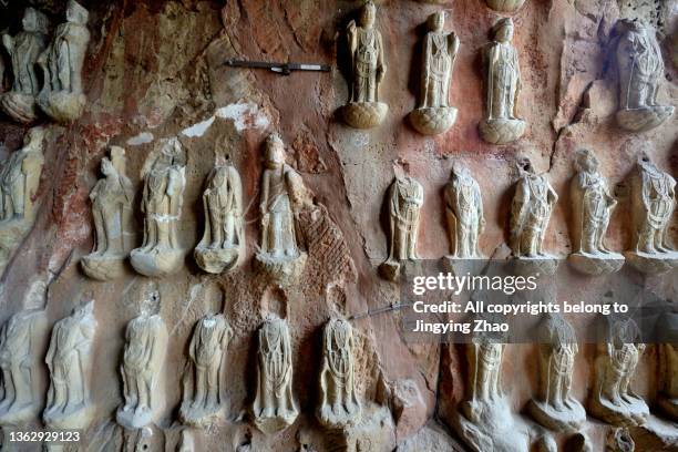 a group of stone buddha statues remaining on the stone wall of sichuan，china - khmer stock pictures, royalty-free photos & images