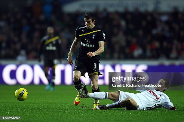 Gareth Bale of Tottenham is tackled by Angel Rangel of Swansea during the Barclays Premier Legaue match between Swansea City and Tottenham Hotspur at...