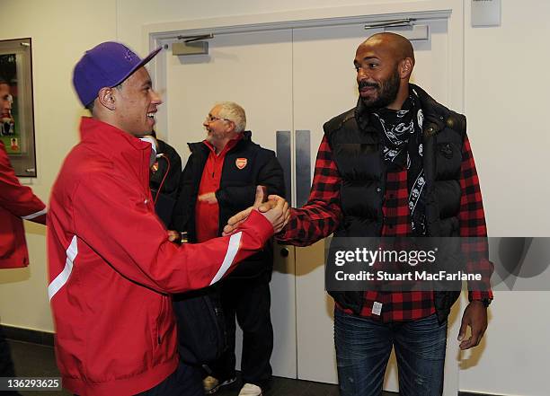 Thierry Henry of the New York Red Bulls shakes hands with Arsenal's Francis Coquelin before the Barclays Premier League match between Arsenal and...