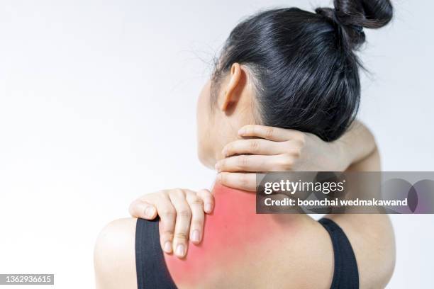 joint pain. woman has neck problems. white background woman in black underwear back view medical advertising or concept - joint effort stock pictures, royalty-free photos & images