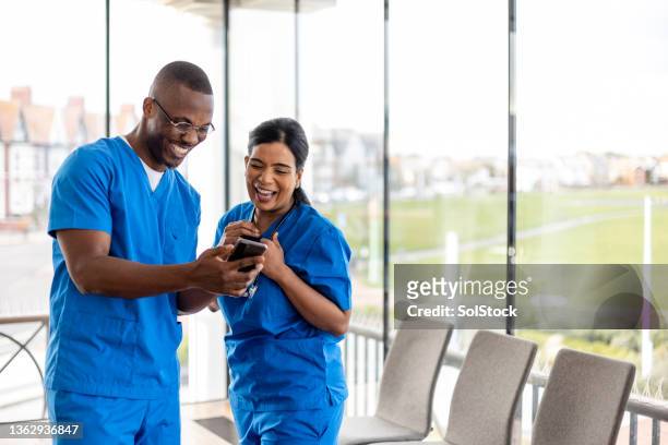 having fun on shift - doctor using phone stock pictures, royalty-free photos & images