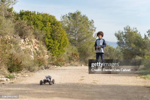 close-up of an out-of-focus radio-controlled prototype car driven by a boy - remote control car stock pictures, royalty-free photos & images