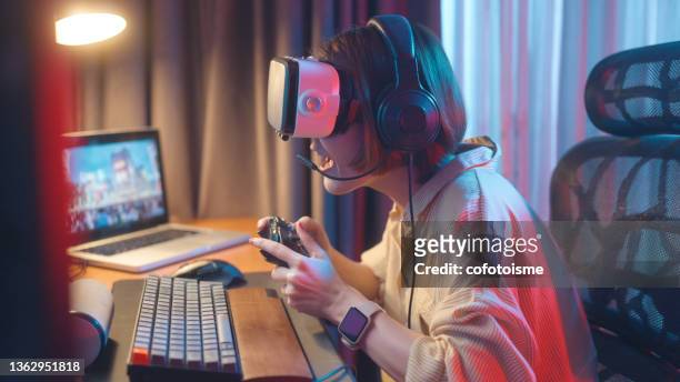 virtual reality gaming and metaverse concept, women have fun playing vr games at home - asian championship bildbanksfoton och bilder