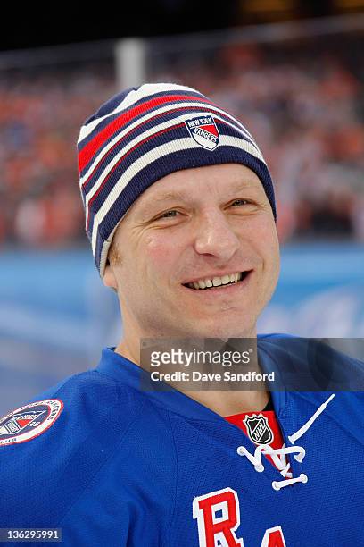 New York Rangers alumni Darius Kasparaitis smiles on the ice before the Alumni game prior to the 2012 Bridgestone NHL Winter Classic at Citizens Bank...
