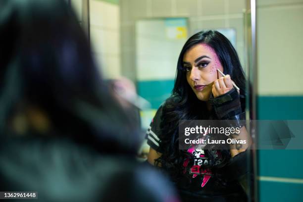 roller derby girl putting on her makeup before the game - showus makeup stock pictures, royalty-free photos & images