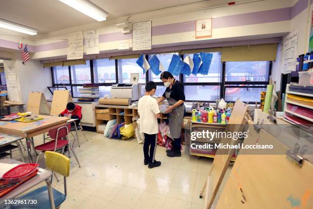 Rebecca Riley, an art teacher at Yung Wing School P.S. 124, gives students a lesson in her classroom on January 05, 2022 in New York City. Mayor Eric...