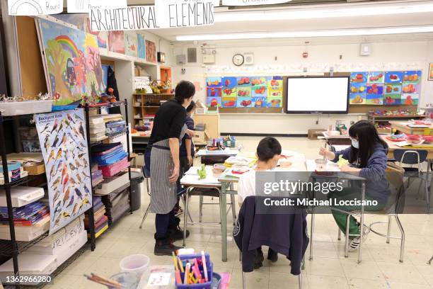 Rebecca Riley, an art teacher at Yung Wing School P.S. 124, gives students a lesson in her classroom on January 05, 2022 in New York City. Mayor Eric...