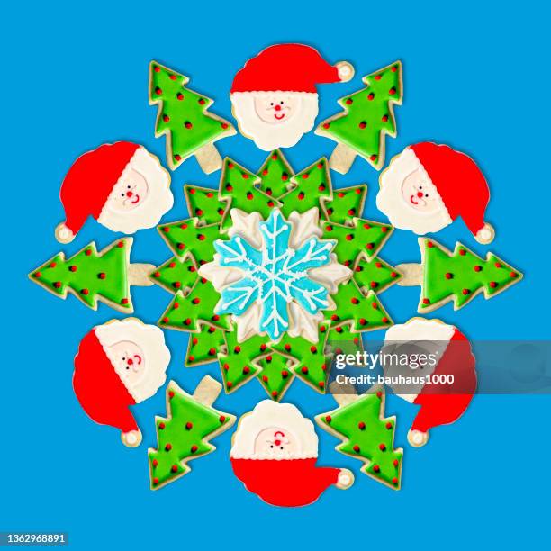 christmas tree, santa and snowflake: christmas wreath created using festive decoratively iced christmas cookies - cookie decorating stock illustrations