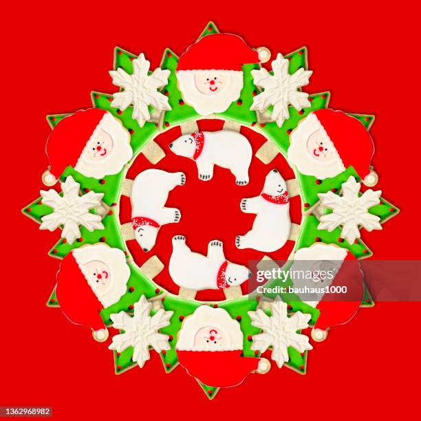 christmas tree, santa, polar bear and snowflake: christmas wreath created using festive decoratively iced christmas cookies - cookie decorating stock illustrations