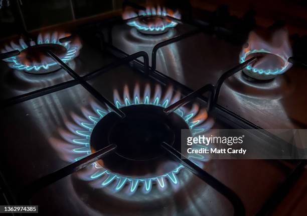 In this photo illustration gas burns on the hob of a domestic cooker in kitchen in a residential property on January 1, 2022 in Bristol, England. The...