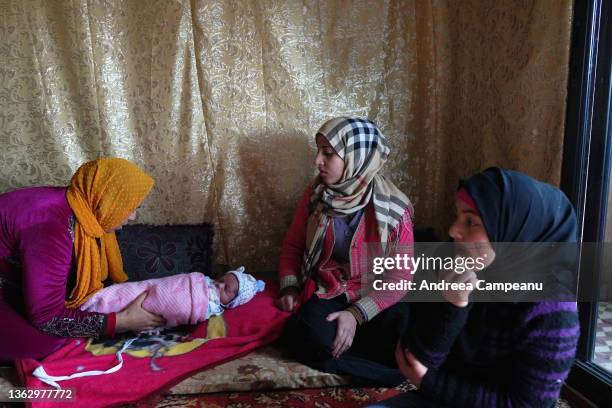 Aisha Mohammed Ali a mother of five who is a refugee from Aleppo, Syria, attends to her newborn on January 5, 2022 in Tripoli, Lebanon. Tripoli is...