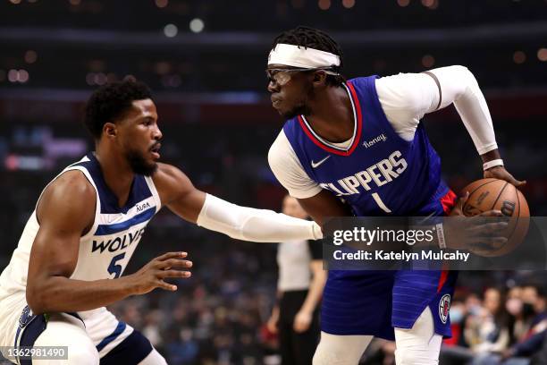 Reggie Jackson of the Los Angeles Clippers handles the ball against Malik Beasley of the Minnesota Timberwolves during the first quarter at...