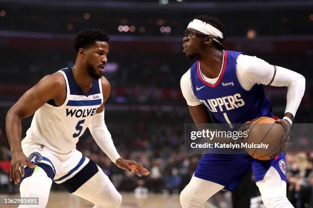 Reggie Jackson of the Los Angeles Clippers handles the ball against Malik Beasley of the Minnesota Timberwolves during the first quarter at...