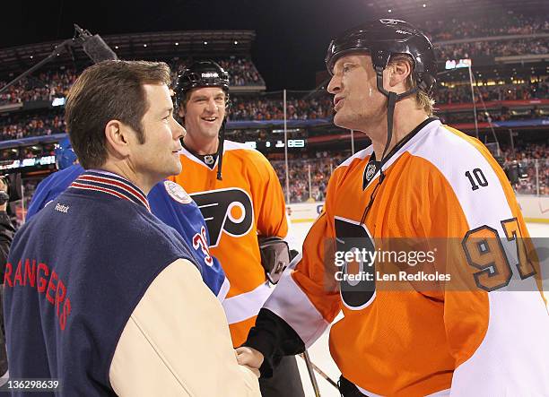 Jeremy Roenick and Derian Hatcher of the Philadelphia Flyers greet Mike Richter of the New York Rangers after a 3-1 Flyers win during the Alumni Game...