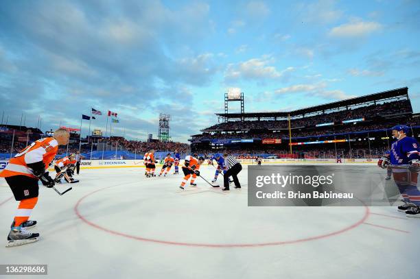 Alumni Dave Poulin of the Philadelphia Flyers faces off with alumni Mark Messier#11 of the New York Rangers during the Alumni game prior to the 2012...